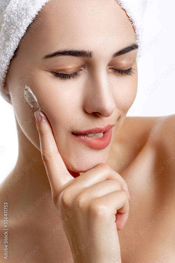 Girl with towel on head on white background,with clear skin Girl with towel on head on white background,with clear skin