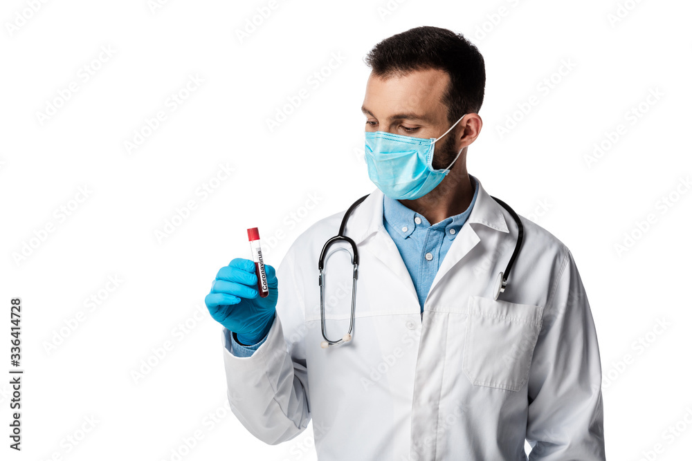 doctor in medical mask and white coat looking at test tube with sample and coronavirus lettering isolated on white doctor in medical mask and white coat looking at test tube with sample and coronavirus lettering isolated on white