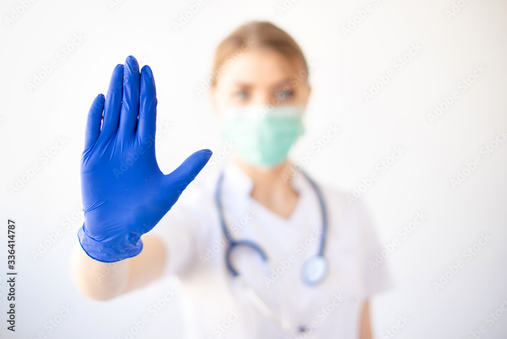Hands blue doctor's protective gloves showing stop gesture, not allowed Hands blue doctor's protective gloves showing stop gesture, not allowed
