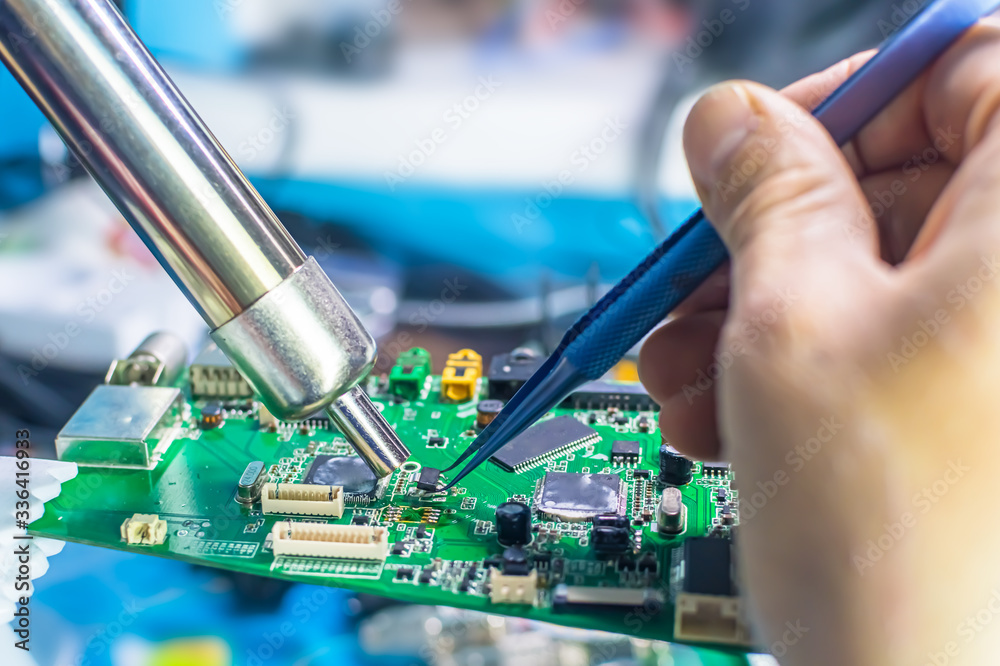 Technical support worker drops the fee PCB. Soldering iron. Tweezers Stock  Photo | Adobe Stock