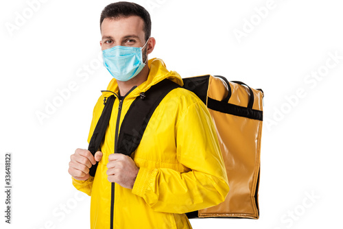 delivery man in blue medical mask and backpack with order isolated on white