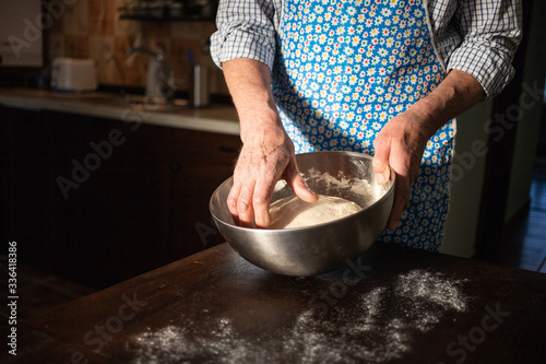 male hands making bread in kitchen at home