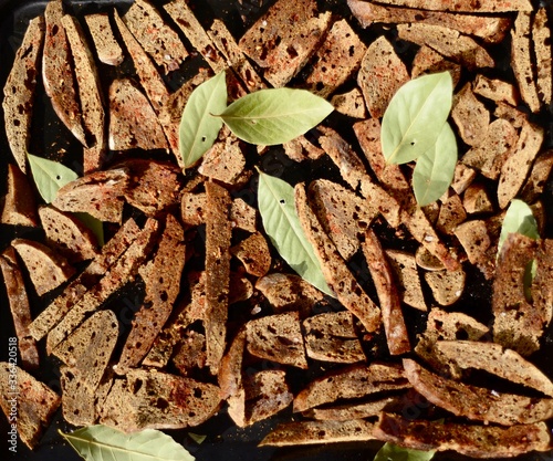  Background from croutons. Rye croutons with spices and bay leaves. Organic food. Vegetarianism.