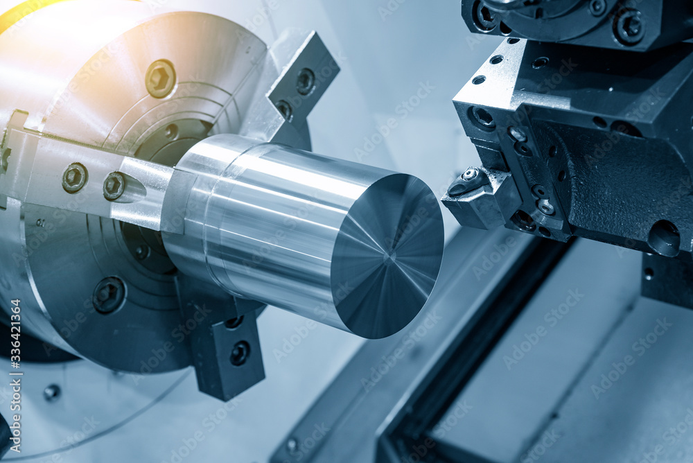 The CNC lathe machine rough cutting the metal shaft parts with lighting  effect. The hi-technology metal working processing by CNC turning machine .  foto de Stock | Adobe Stock