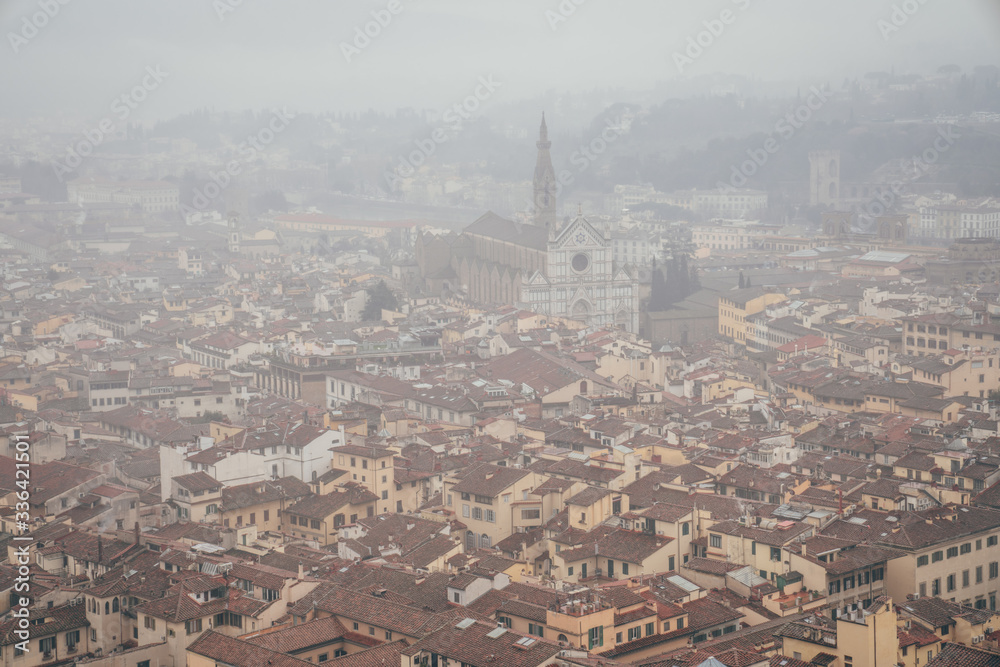 view of the basilica of Santa Croce from the dome of the Florence Cathedral on a foggy day