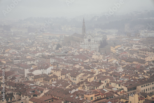 view of the basilica of Santa Croce from the dome of the Florence Cathedral on a foggy day © ylenia cancelli