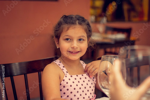 Portrait of a little girl smiling on a restaurant.