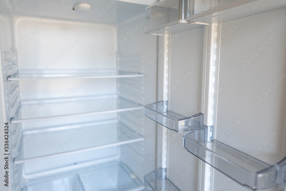 Empty shelves in refrigerator. The concept of diet and hunger Empty shelves in refrigerator. The concept of diet and hunger