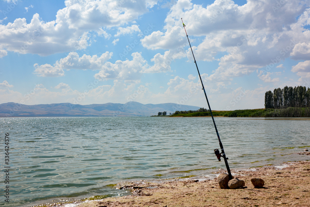 amateur fishing with fishing rod on the lake amateur fishing with fishing rod on the lake