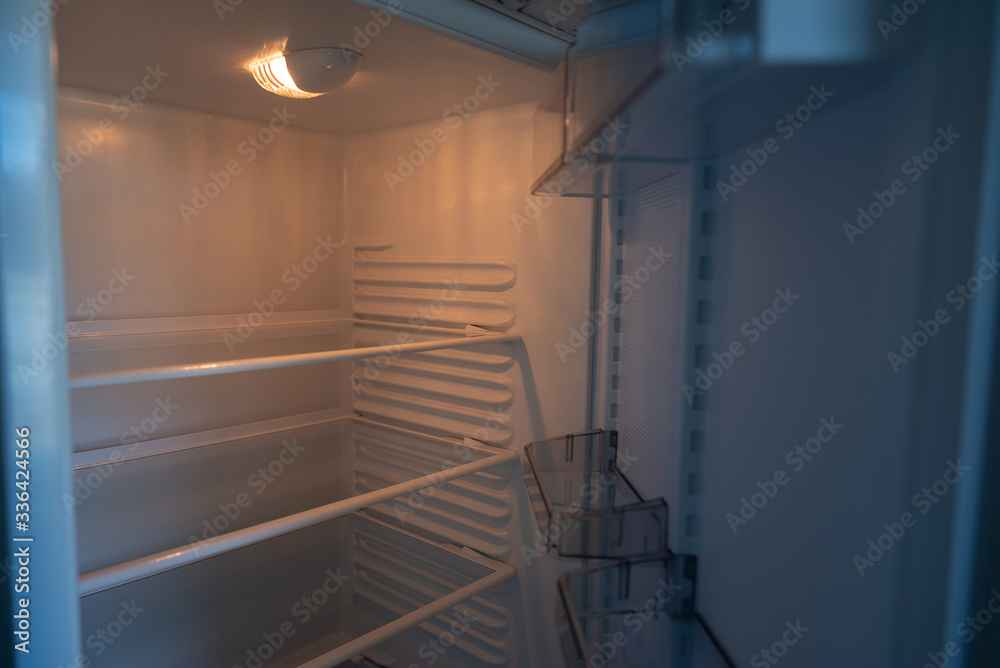 Empty shelves in refrigerator. The concept of diet and hunger Empty shelves in refrigerator. The concept of diet and hunger