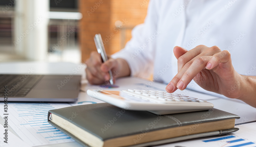 Accounting businessmen are calculating income-expenditure and analyzing real estate investment data, Financial and tax systems concept. Accounting businessmen are calculating income-expenditure and analyzing real estate investment data, Financial and tax systems concept.