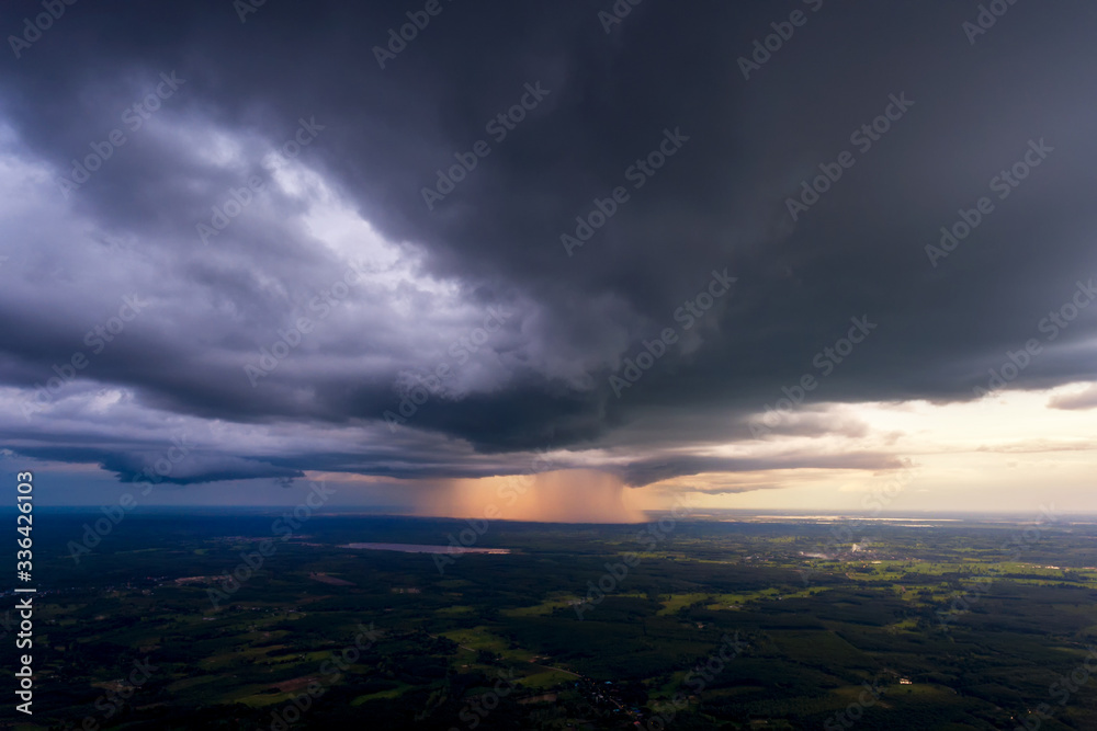 View of thunderstorm clouds Above the field of sunsets
