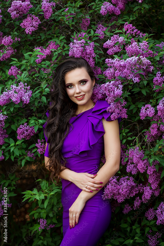 beautiful young girl in a purple dress in bloom of lilacs, photo shoot of a girl, beautiful lilac