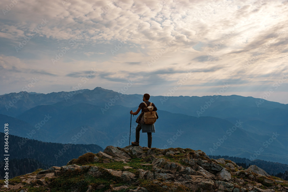 Young male hipster in the mountains in autumn