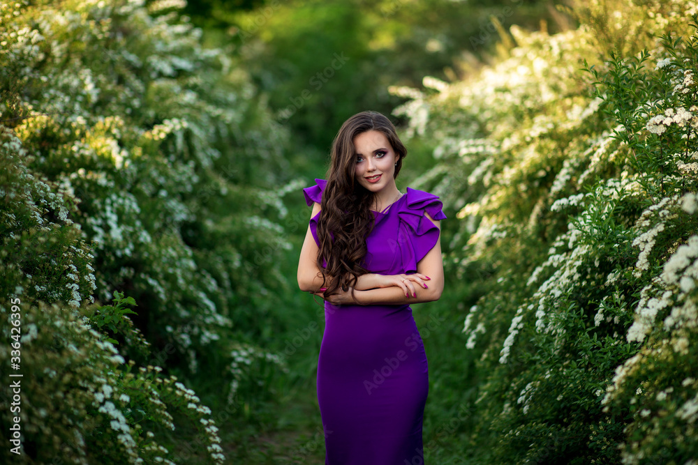 beautiful young girl in a purple dress in bloom of white flowers, photo shoot of a girl beautiful young girl in a purple dress in bloom of white flowers, photo shoot of a girl