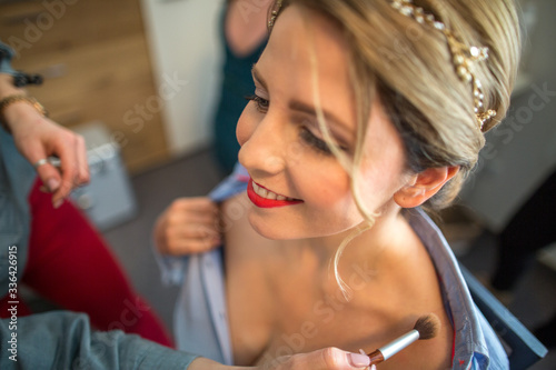 Make up artist work in her beauty visage studio salon. Woman applying by professional make up master. Beauty club concept.