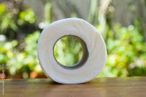 Toilet paper roll. Soft hygienic paper on wooden background.; nature background photo