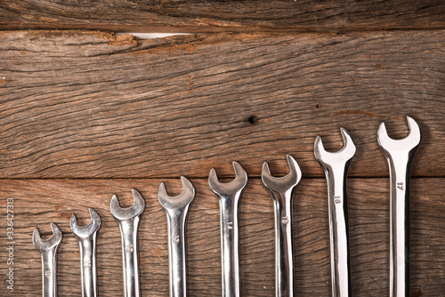 wrenches on wooden background