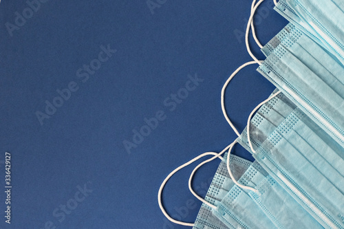 Medical surgical facial mask. Medical protective masks on a blue background. Protection concept. World Coronavirus Pandemic - Covid-19