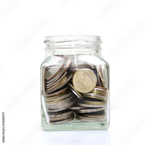 Coins in glass or  Money in glass Isolated on a White Background