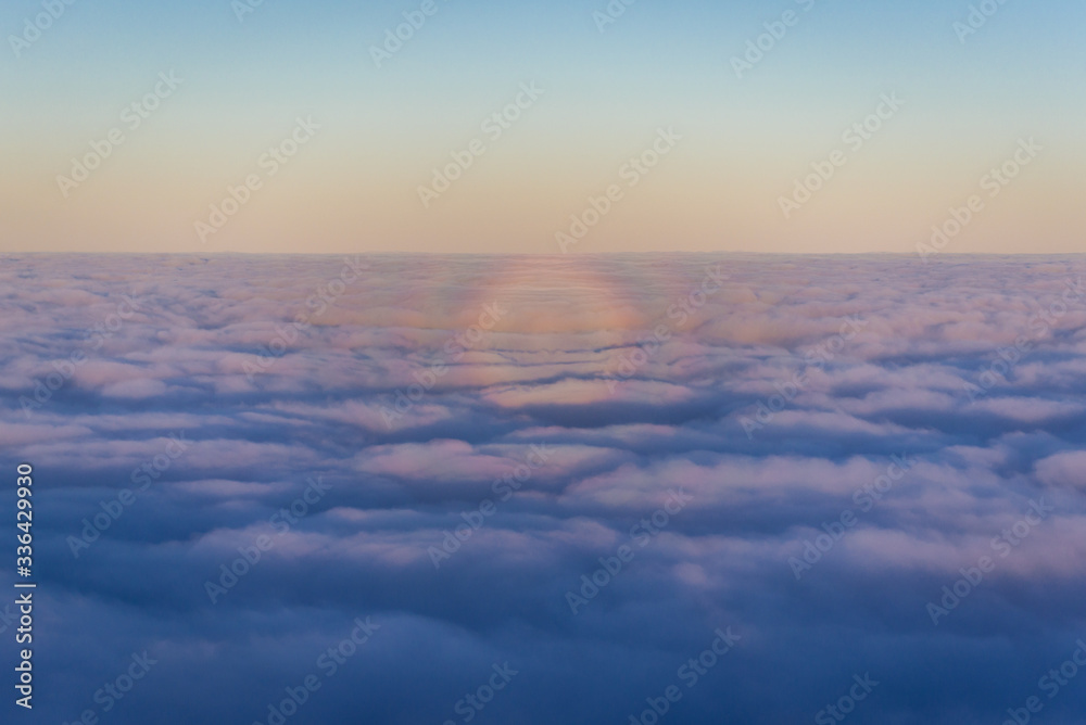 Optical phenomenon over moring clouds seen from plane window