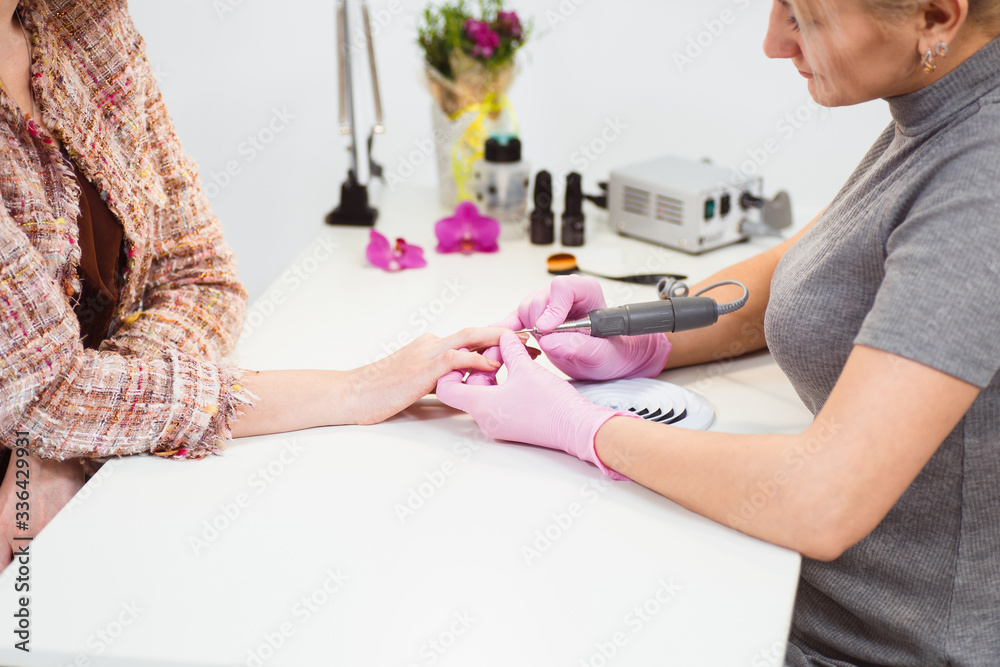 Close to the hands of the master and client during the manicure Close to the hands of the master and client during the manicure