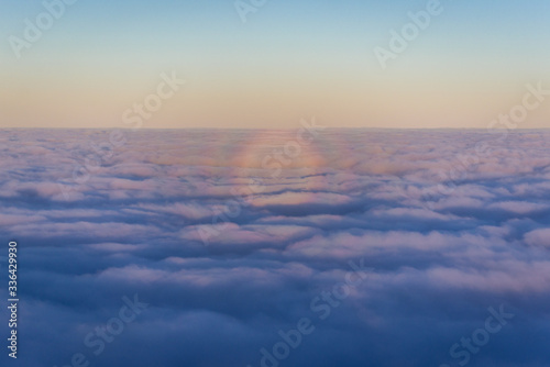 Optical phenomenon over moring clouds seen from plane window