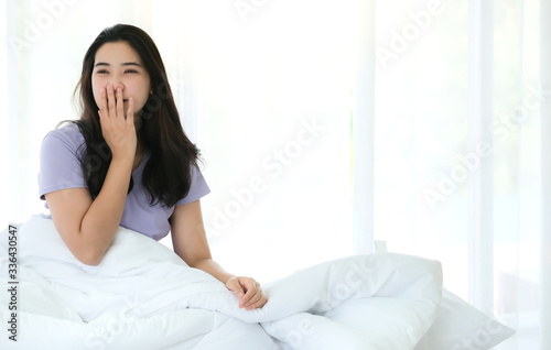 Young beautiful Asia woman wake up and feeling relaxing in the morning isolated on white background. Feeling fresh and ready. Resting, good dream and sleep concept.