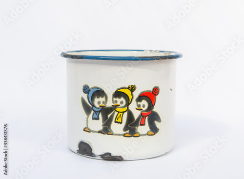 Vintage enamaled metal mug with penguins pattern - penguin children with knitted scarf and cup - old enamel tin cup photo