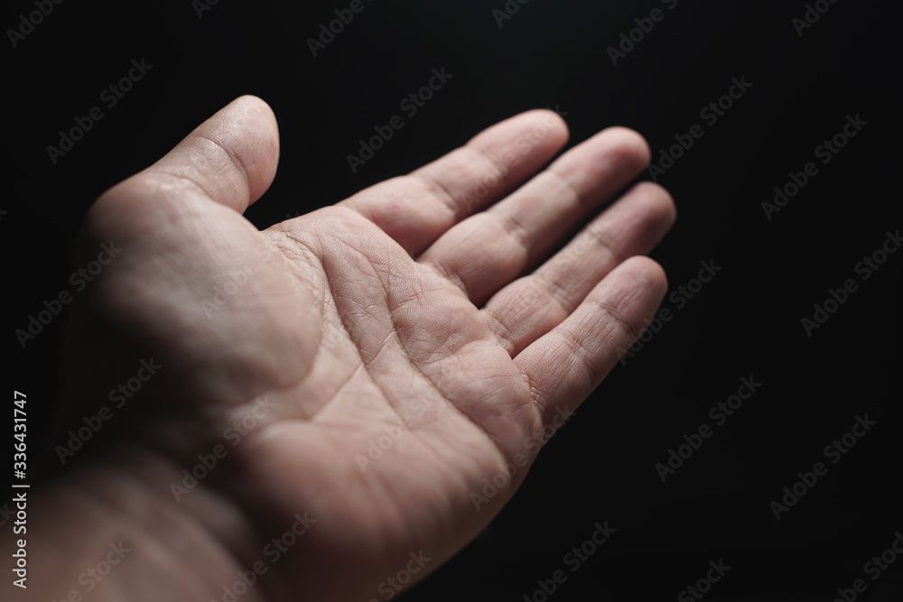 Close-up of a man's hand, palms on a black background. Close-up of a man's hand, palms on a black background.