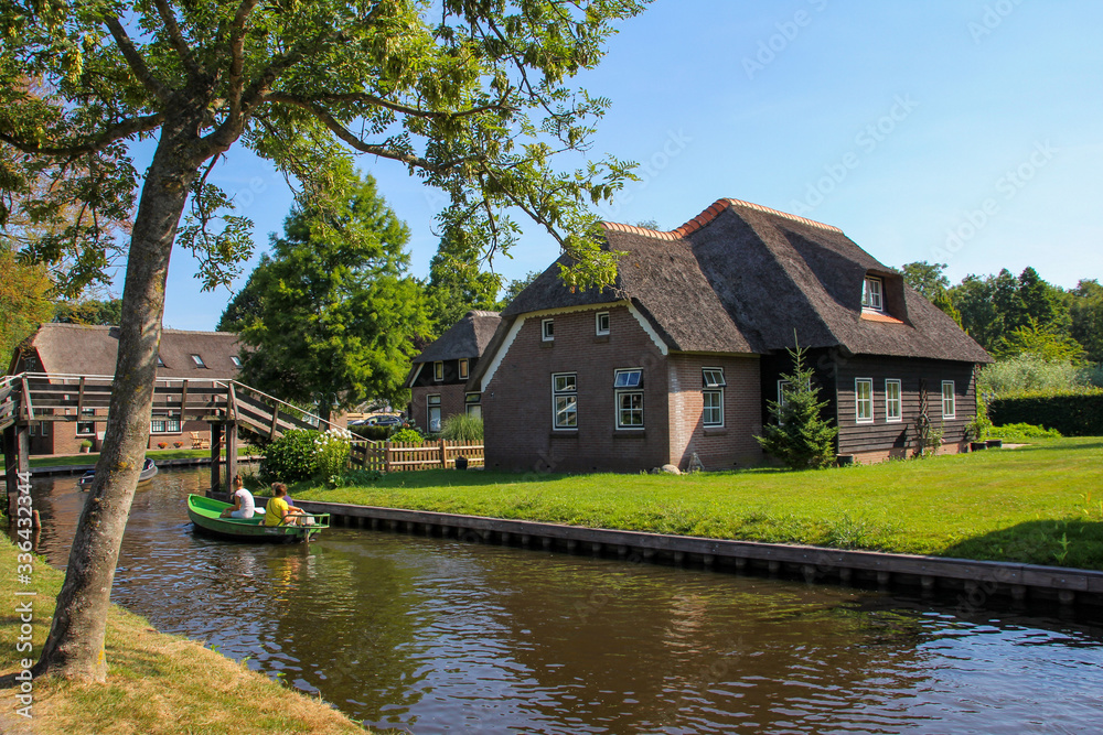 Giethoorn Canal with house and boat Giethoorn Canal with house and boat