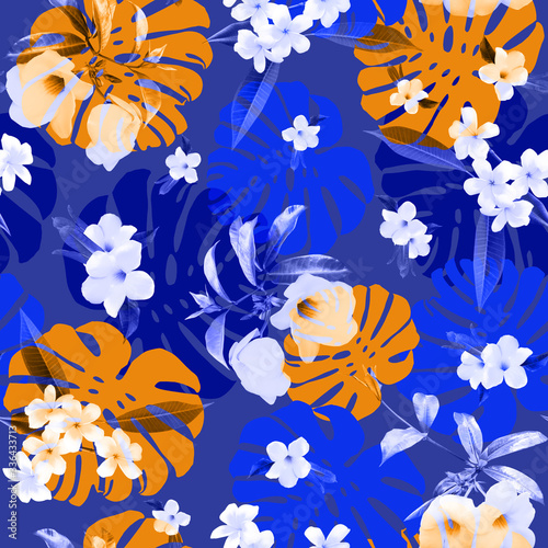 Fototapeta Naklejka Na Ścianę i Meble -  seamless tropical floral pattern. Monstera leaves, and plumeria flowers, frangipani on a blue background.