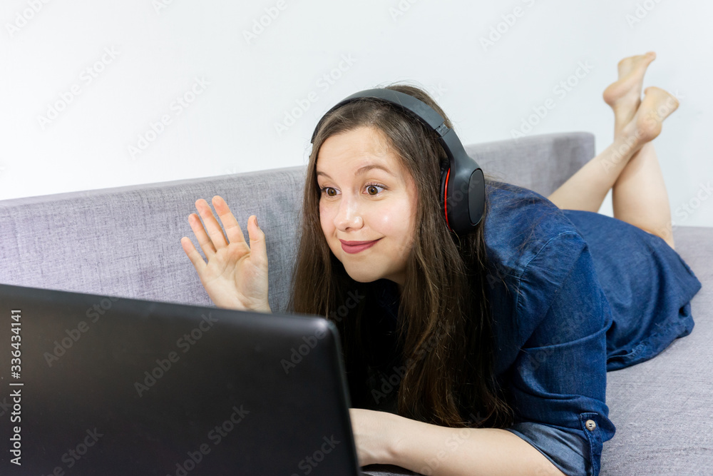 girl student wear headphone study online with video call. woman watch laptop at home. Covid-19 coronavirus. girl student wear headphone study online with video call. woman watch laptop at home. Covid-19 coronavirus.