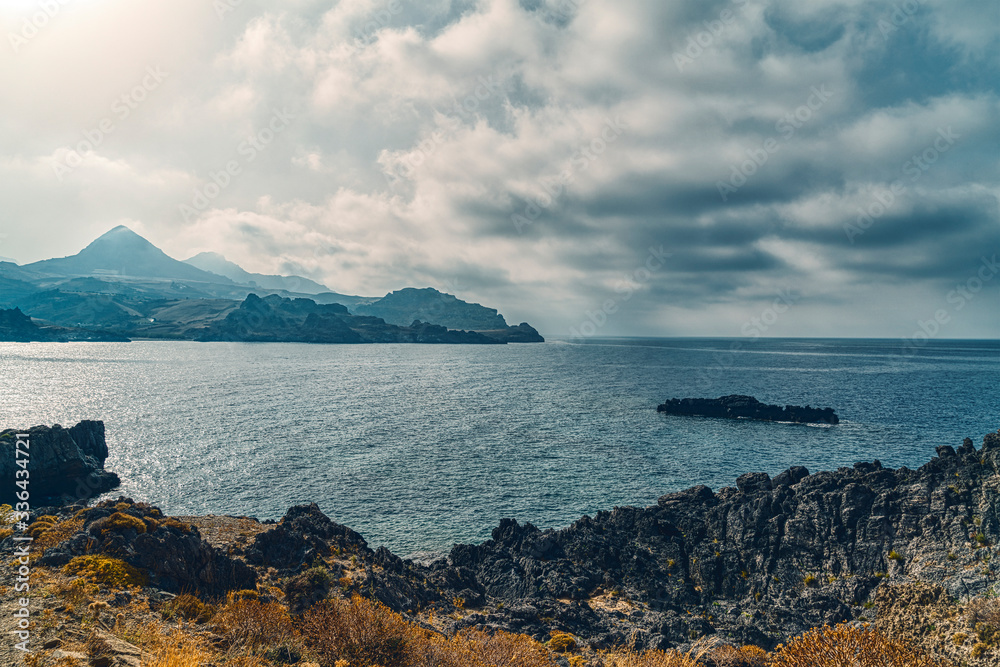 Bay and mountain ranges with dramatic skies in Crete