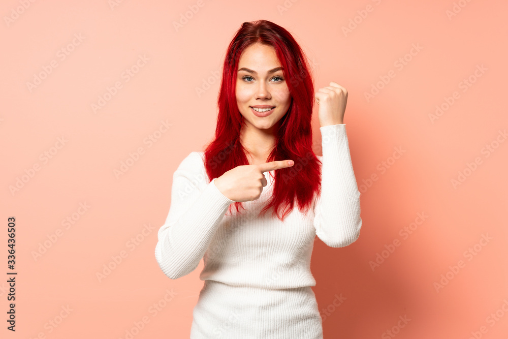 Teenager red hair girl isolated on pink background making the gesture of being late Teenager red hair girl isolated on pink background making the gesture of being late