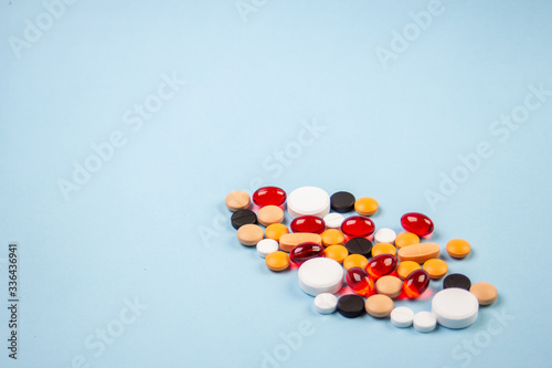 pills of different colors on a blue background 