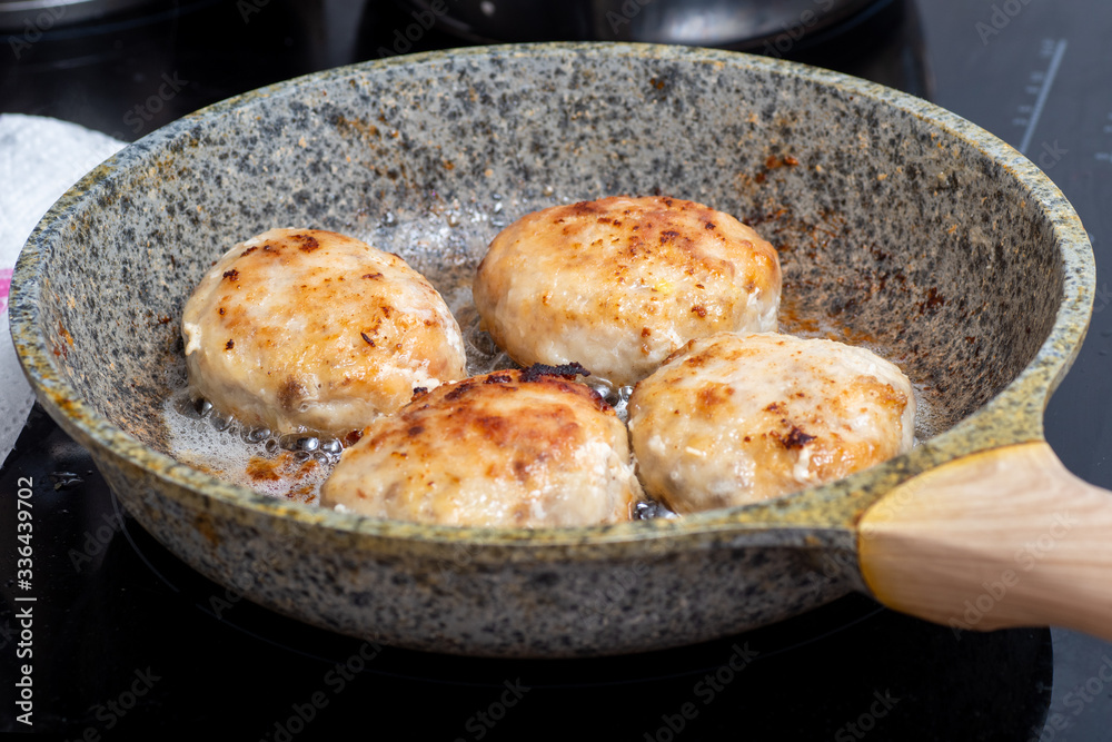 The process of cooking in a pan with fried meat, meatballs, barbecue. Fast Food concept - closeup of cutlets The process of cooking in a pan with fried meat, meatballs, barbecue. Fast Food concept - closeup of cutlets