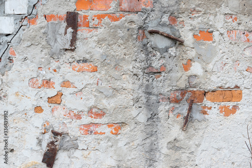 Texture of old red brickwork with iron reinforcement and cement mortar. Background brick wall and plaster with rusty iron
