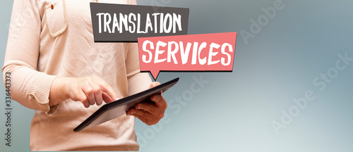 closeup woman holding tablet, speech bubbles with translation and services concept  photo