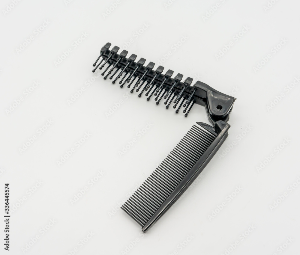 Two ways folding hair brush pocket comb. Black fish bone shape comb isolated on white Two ways folding hair brush pocket comb. Black fish bone shape comb isolated on white