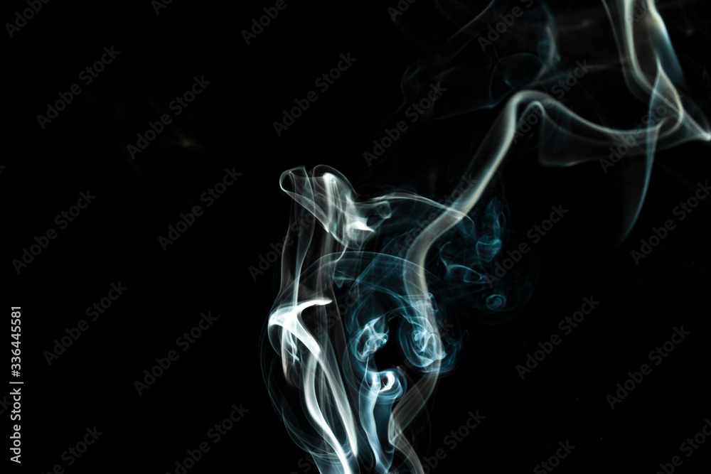puffs of white smoke with a black background puffs of white smoke with a black background