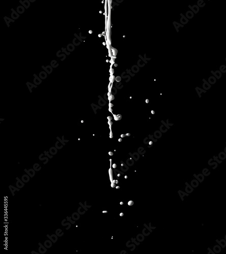 spray of milk on black background