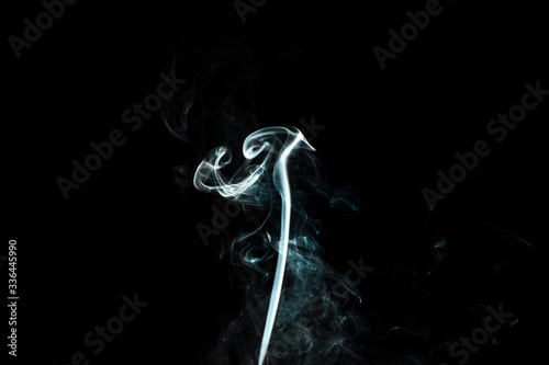 puffs of white smoke with a black background