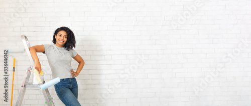 Fotografija Homemade design. African american woman on stepladder