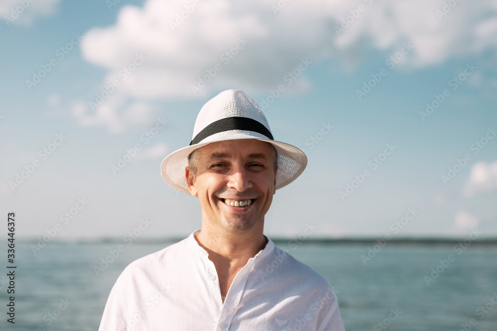 close-up portrait of a man on the beach against the background of the water