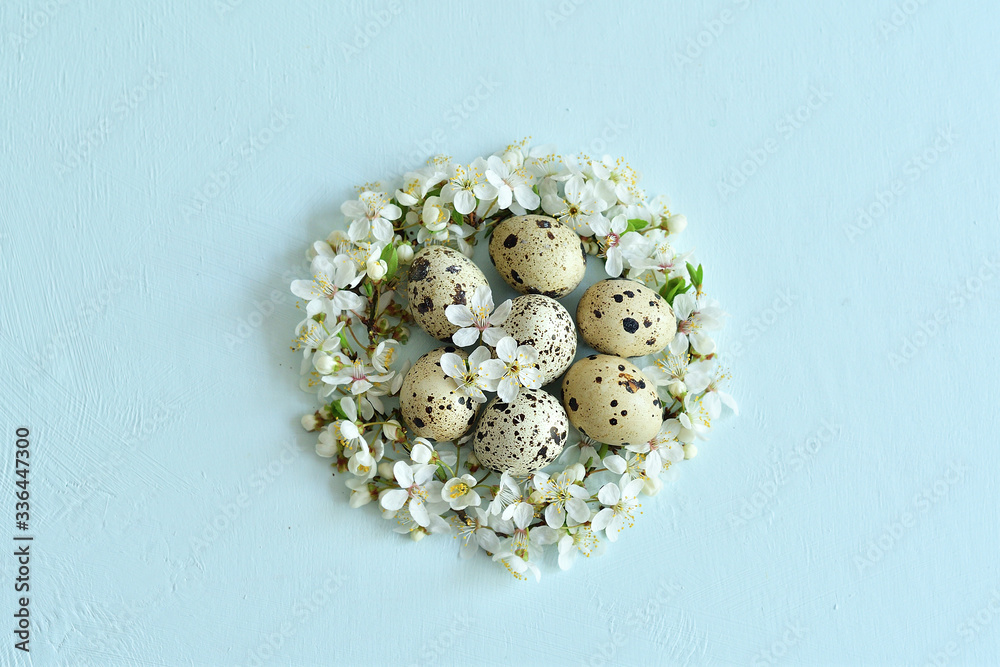 Easter background with Easter eggs in nest of spring flowers. Top view with copy space. Happy Easter Spring Festive greeting card. Holidays arrangement. Easter background with Easter eggs in nest of spring flowers. Top view with copy space. Happy Easter Spring Festive greeting card. Holidays arrangement.