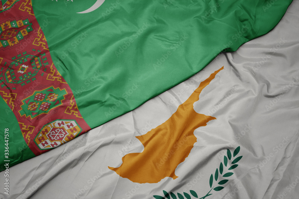 waving colorful flag of cyprus and national flag of turkmenistan.