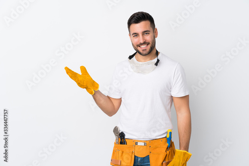 Картината върху платно Craftsmen or electrician man over isolated white background holding copyspace im