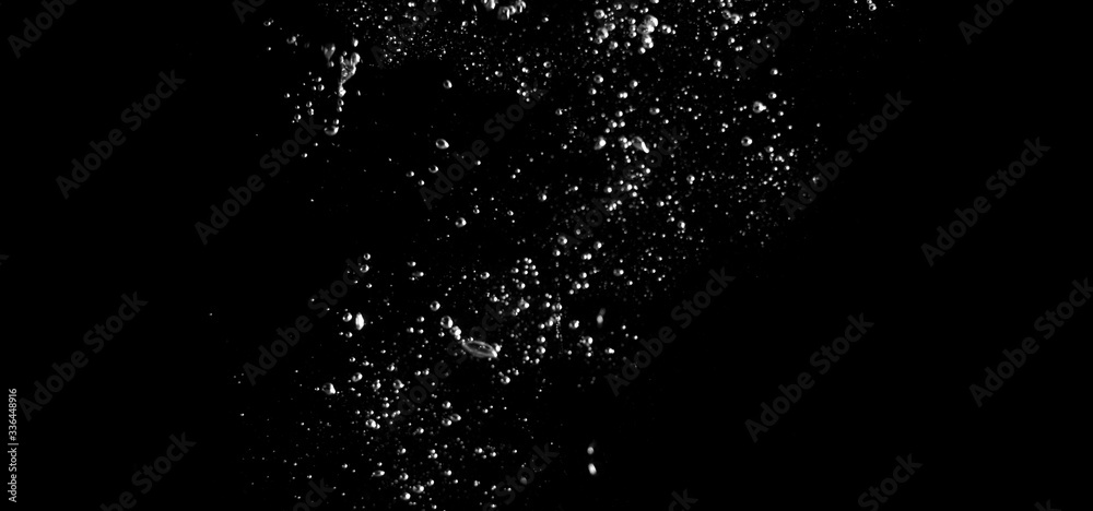 Blurry images of real soda bubbles floating and splashing up in black background which represent freshness of carbornate drink or sparkling water and shoot from realistic water moving not 3D making