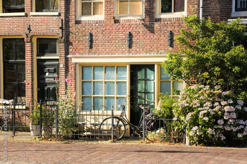 Typical entrance to a Dutch house with a small garden and a bicycle